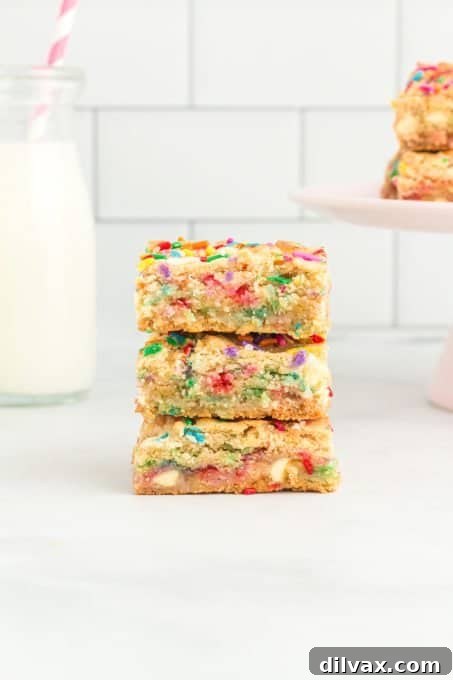 A vibrant display of Funfetti Ooey Gooey Bars with their signature sprinkles, ready to be enjoyed as a sweet treat.