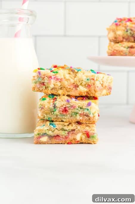 An easy bar recipe with colorful sprinkles, cut into squares on a white background.
