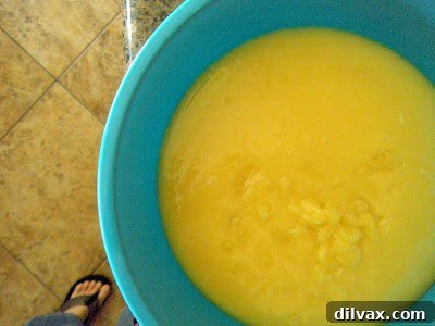 Smooth, vibrant yellow homemade lemon curd in a glass bowl, ready for use.