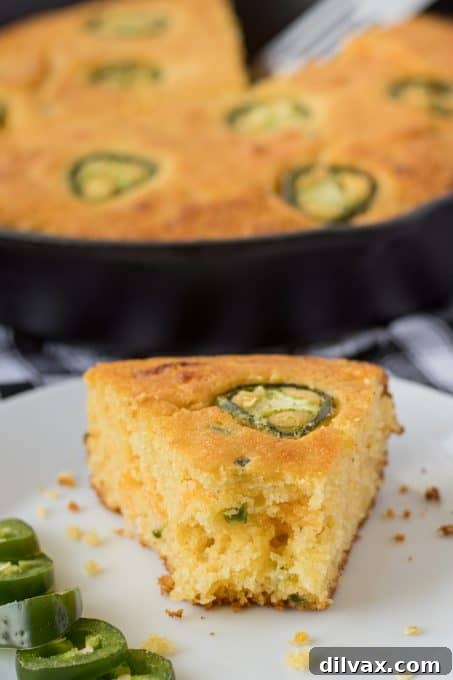 Jalapeño cornbread made in a cast iron skillet, showcasing the full round loaf.