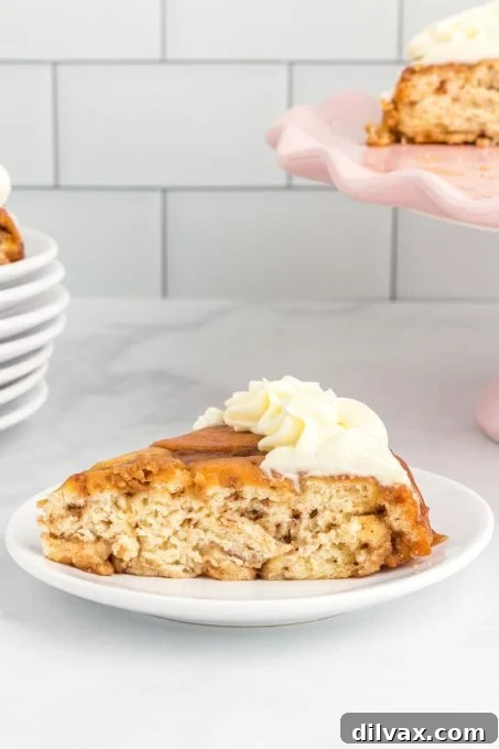 A cake slice made out of cinnamon rolls with cream cheese icing.