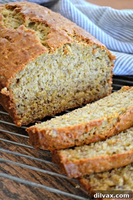Superfood Quinoa Banana Bread 3 Close-up of a slice of Quinoa Banana Bread showing the moist texture and speckles of quinoa throughout.