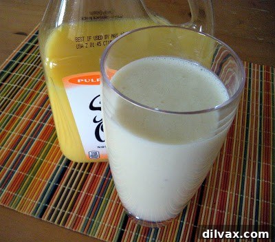 Two glasses of Orange Dream Smoothie garnished with orange slices, ready to drink.