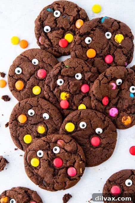 Monster Mash Cookies 6 A batch of freshly baked chocolate cookies, decorated with colorful M&M's and spooky candy eyes.