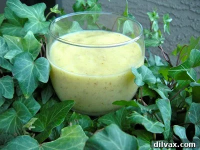 Delicious Pineapple Mango Smoothie in a tall glass, garnished with fresh fruit slices, ready to be enjoyed on a warm day.