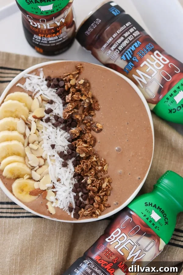 A beautifully arranged Banana Mocha Smoothie Bowl topped with banana slices, chocolate chips, and other fresh ingredients.