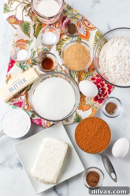 Pumpkin Cheesecake Bread 4 Arrangement of fresh ingredients for Cream Cheese Pumpkin Bread, including pumpkin puree, spices, flour, and softened cream cheese.