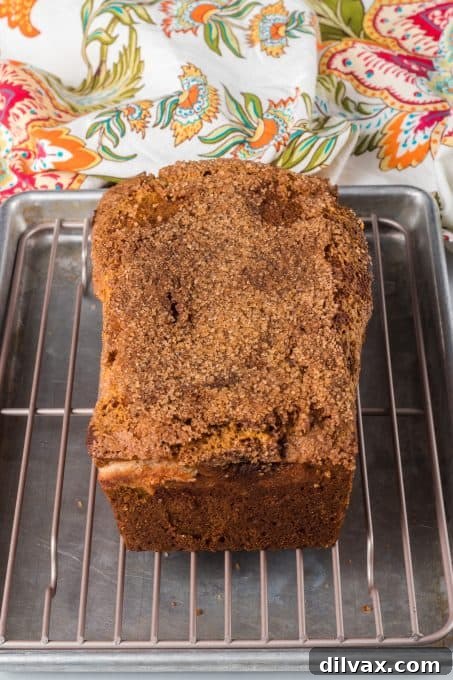 Pumpkin Cheesecake Bread 7 Sliced Pumpkin Bread with a rich cream cheese swirl and a golden-brown top, ready to be enjoyed.