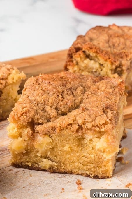 Spiced Apple Streusel Cake 8 A whole Apple Crumb Cake freshly baked in a baking dish, adorned with a cinnamon streusel topping.
