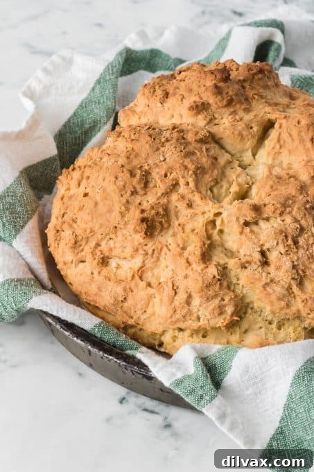 Emerald Isle's Easiest Soda Bread 3 A close-up shot of a sliced loaf of Irish Soda Bread, showcasing its tender, dense crumb