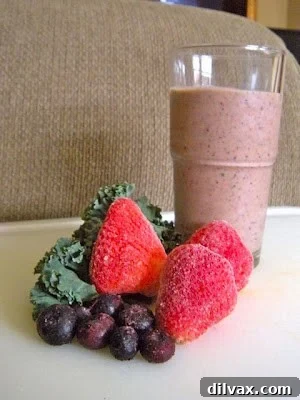 Unveiling the Secret Recipe Club's Berry Blast Green Smoothie 5 Two inviting glasses of Berry Blast Green Smoothie, one with a straw, ready to be enjoyed as a healthy and refreshing drink.