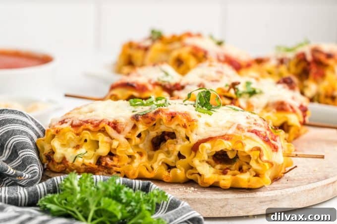 Close-up of baked Lasagna Pasta Skewers on a plate, garnished with fresh basil.