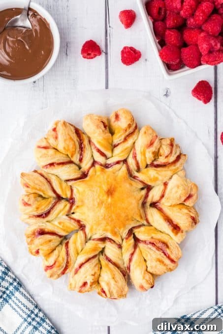 Swirling Raspberry Star Bread 2 A beautifully baked Raspberry Star Bread, a celebration bread with intricate twists, bursting with raspberries and jam, ready to be enjoyed.