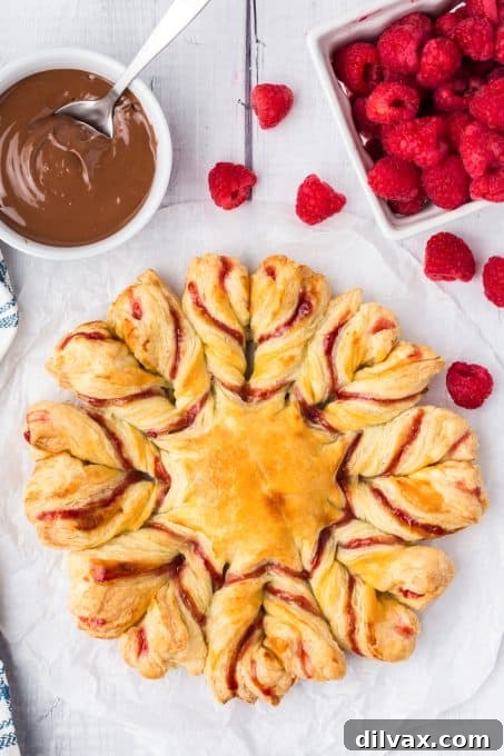 Swirling Raspberry Star Bread 3 Close-up shot of the finished Raspberry Star Bread, showcasing its beautiful twisted pattern and golden-brown crust.