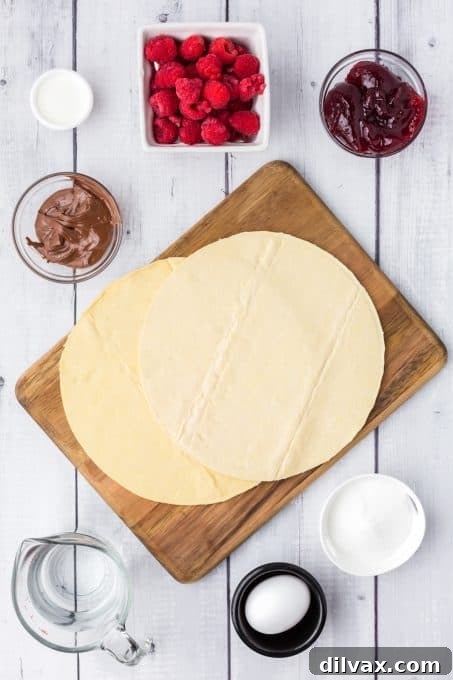 Swirling Raspberry Star Bread 4 Assortment of ingredients for Raspberry Star Bread and Nutella dipping sauce laid out on a wooden surface.