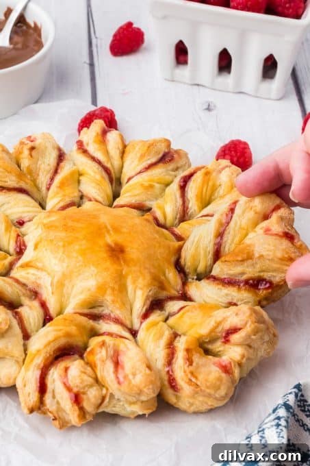 Swirling Raspberry Star Bread 10 A beautifully baked Raspberry Star Bread, showcasing its pull-apart nature and golden-brown twists.