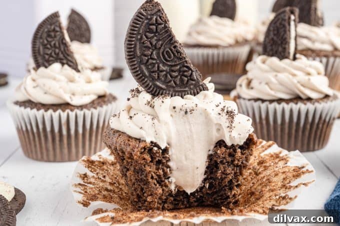 The inside of an Oreo frosted cupcake, showing a rich chocolate cake and creamy frosting.