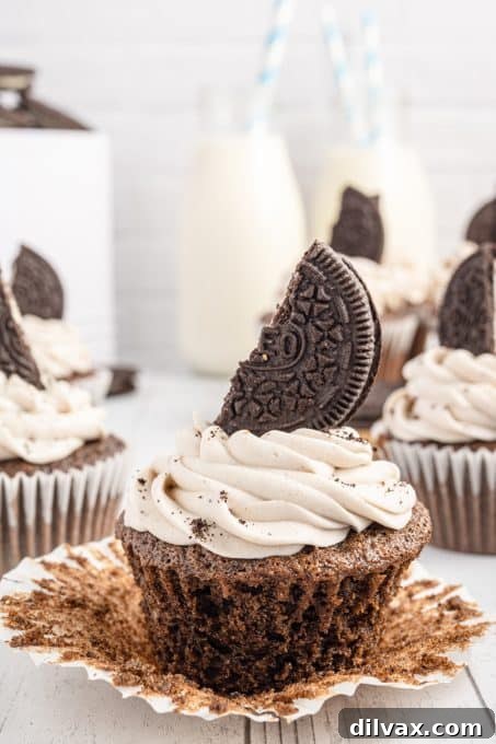 Unwrapping a delicious chocolate cupcake infused with Oreo flavor.