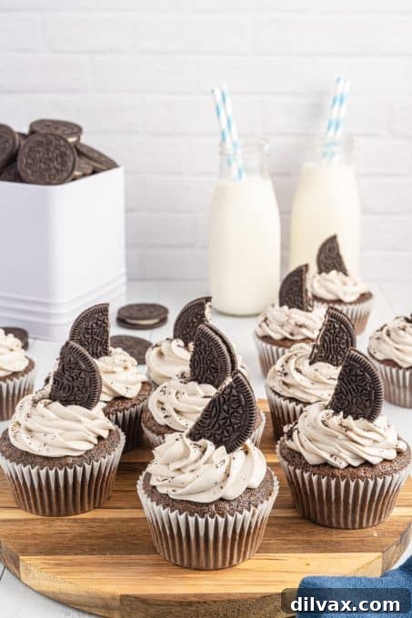 Delicious Oreos carefully placed on top of frosted chocolate Oreo cupcakes.