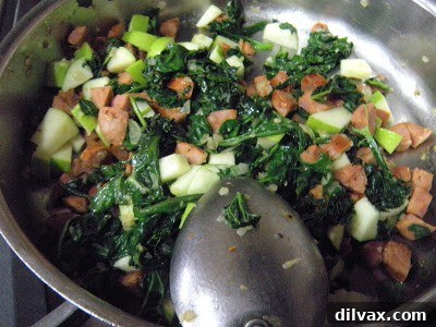Spreading the stuffing mixture onto a butterflied pork loin.