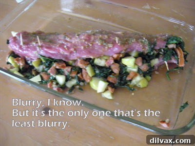 Applying the mustard-sage rub to the stuffed pork loin.