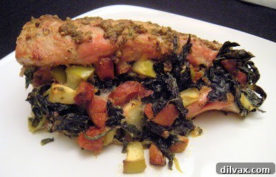 Sliced Mixed Green and Andouille Stuffed Pork Loin on a serving platter.