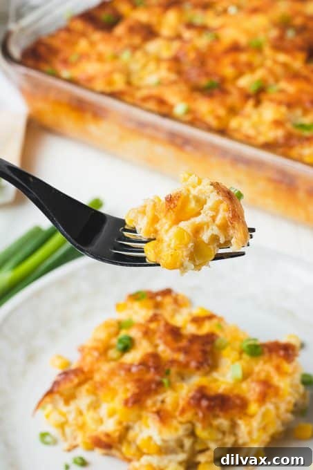 Creamy Corn Delight 12 A forkful of corn pudding on a fork.