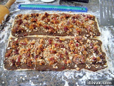 Close-up of Rugelach dough being expertly rolled out on a floured surface.