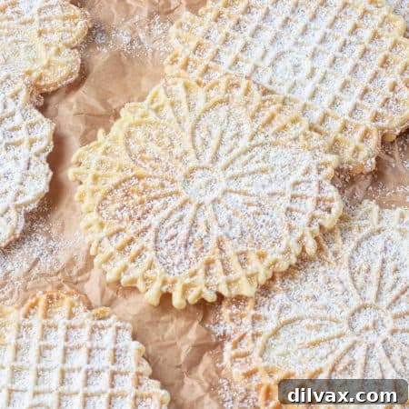 Italian waffle cookies dusted with powdered sugar.