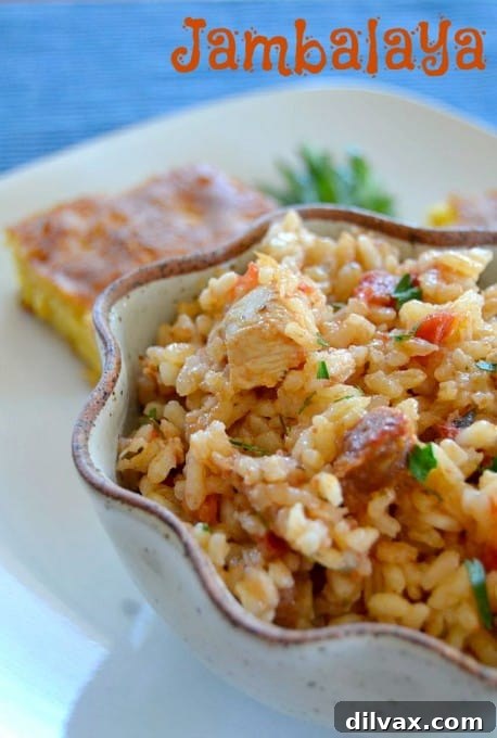 Hearty and spicy Jambalaya dish, a native Louisiana meal with rice, chicken, Andouille sausage, and optional shrimp, served in a rustic bowl.