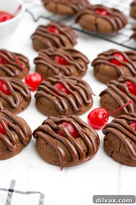 Cherry Kissed Chocolate Cookies 3 Close-up of a single Chocolate Cherry Thumbprint Cookie, highlighting the bright red cherry center.