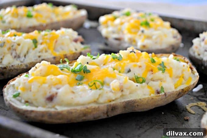 Rich and creamy Twice Baked Potatoes, generously filled with a mixture of cream cheese, Greek yogurt, Old Bay Seasoning, and crispy bacon bits.