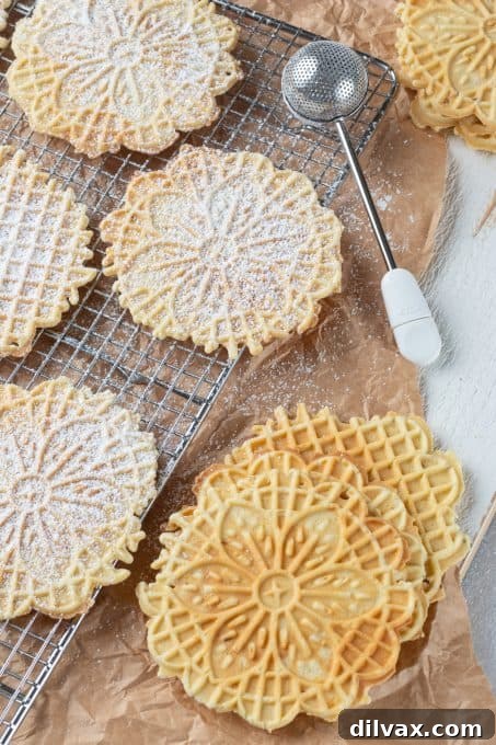 Holiday Cookie Countdown 2022 12 Delicate Pizzelles being dusted with powdered sugar, ready to be served.