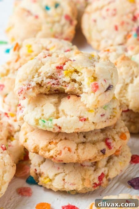Holiday Cookie Countdown 2022 8 A whimsical Fruity Pebbles cookie with a bite taken out, revealing its colorful, chewy texture.