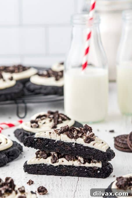 A copycat Oreo cookie from Crumbl broken in half, revealing its soft interior.
