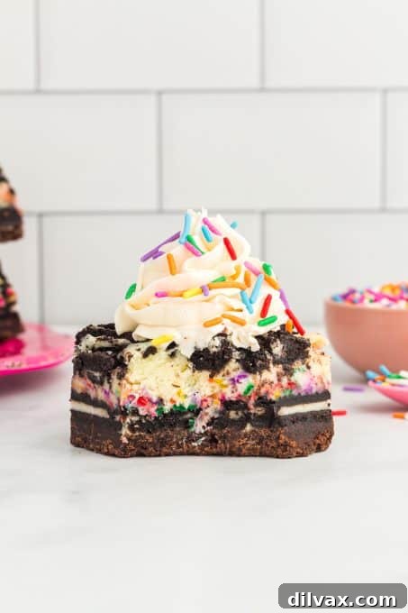 Frosting on a cheesecake bar with Oreos.