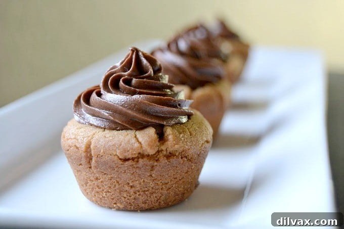 Irresistible Reese's Peanut Butter Cup Cookies 7 Peanut Butter Cookie Cups stuffed with a mini Reese's and topped with chocolate buttercream!