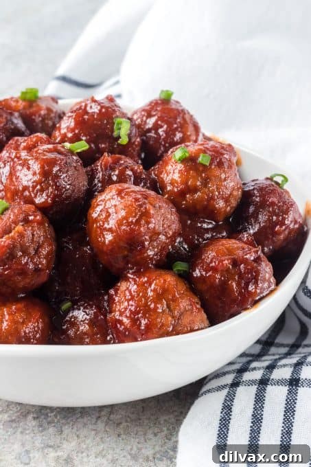 Sweet and Savory Cranberry Meatballs 3 A close-up of a slow cooker filled with Cranberry Meatballs, showing the rich, deep red sauce.