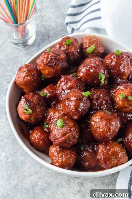 Sweet and Savory Cranberry Meatballs 8 A bowl of Cranberry Meatballs on a serving table, ready for guests, with a focus on their glossy sauce.