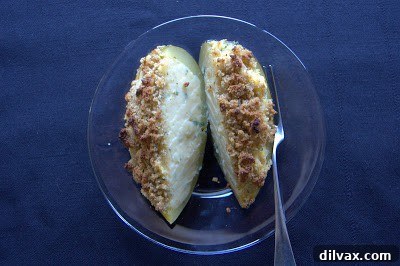 Close-up of the delicious twice-baked acorn squash, showing the creamy filling and crispy topping.