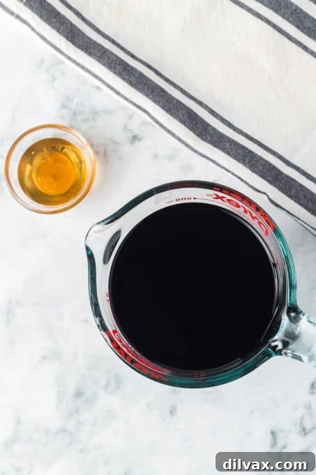 A bottle of high-quality balsamic vinegar and a jar of golden honey are carefully laid out, symbolizing the two essential ingredients for crafting a perfect balsamic reduction.