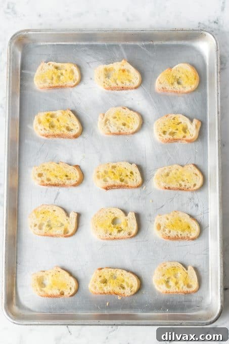 Bread slices brushed with olive oil ready to be toasted.