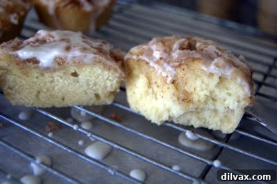Close-up of freshly baked Cinnamon Roll Muffins with a sweet glaze drizzle, showing the delicious cinnamon swirl.