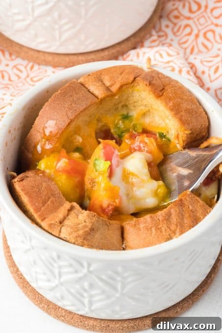 Close-up of baked eggs in toast cups, garnished with herbs