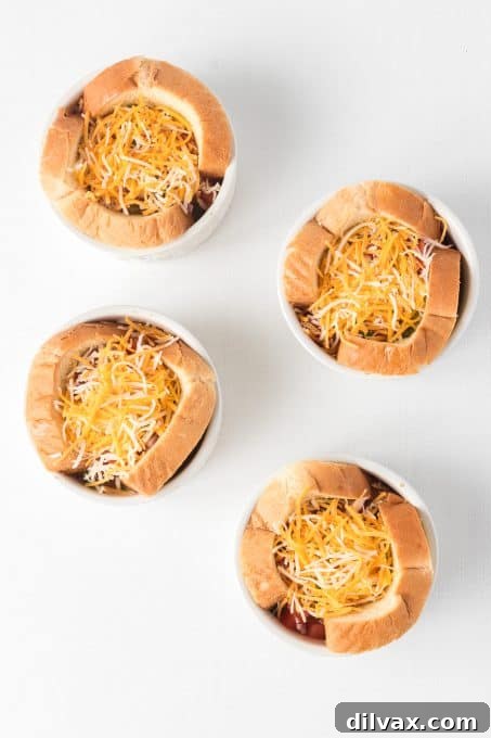 Shredded cheese generously sprinkled over eggs in toast cups, ready for baking.