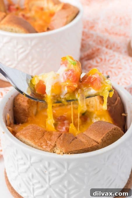 A fork taking the first bite of a baked egg in toast cup, showing the soft yolk and toppings.