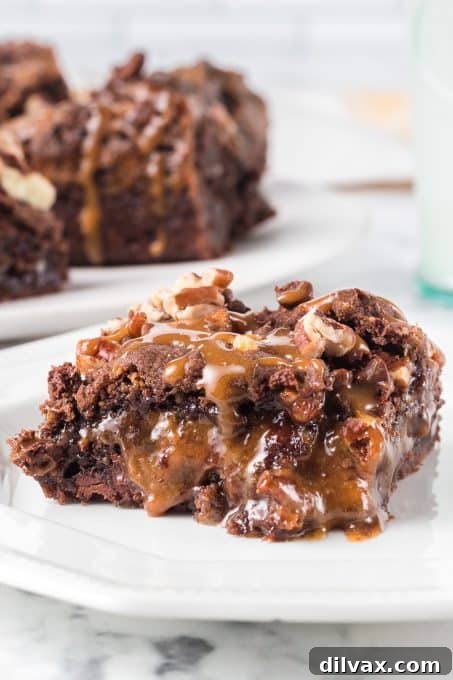 A close-up of a Turtle Ooey Gooey Bar with caramel visibly oozing out, highlighting its rich, soft texture.