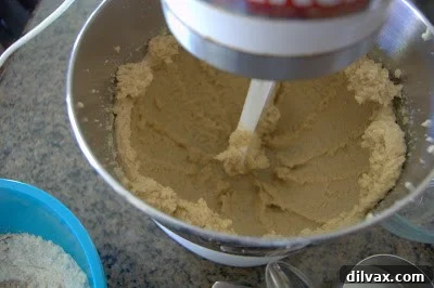 Creaming butter and sugars in a stand mixer.