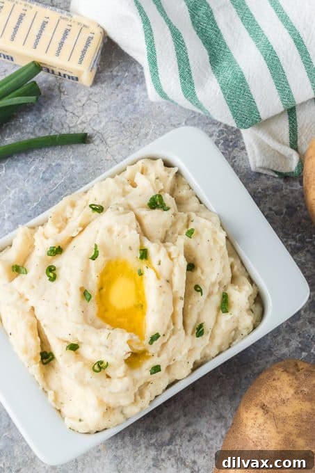 A bowl of mashed potatoes infused with cheese and ranch seasoning