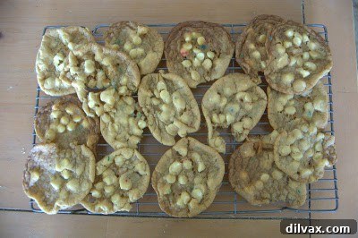 White Chocolate Cake Batter Bliss Bites 7 Baked cookies on a cooling rack, showing golden edges and slightly risen centers.